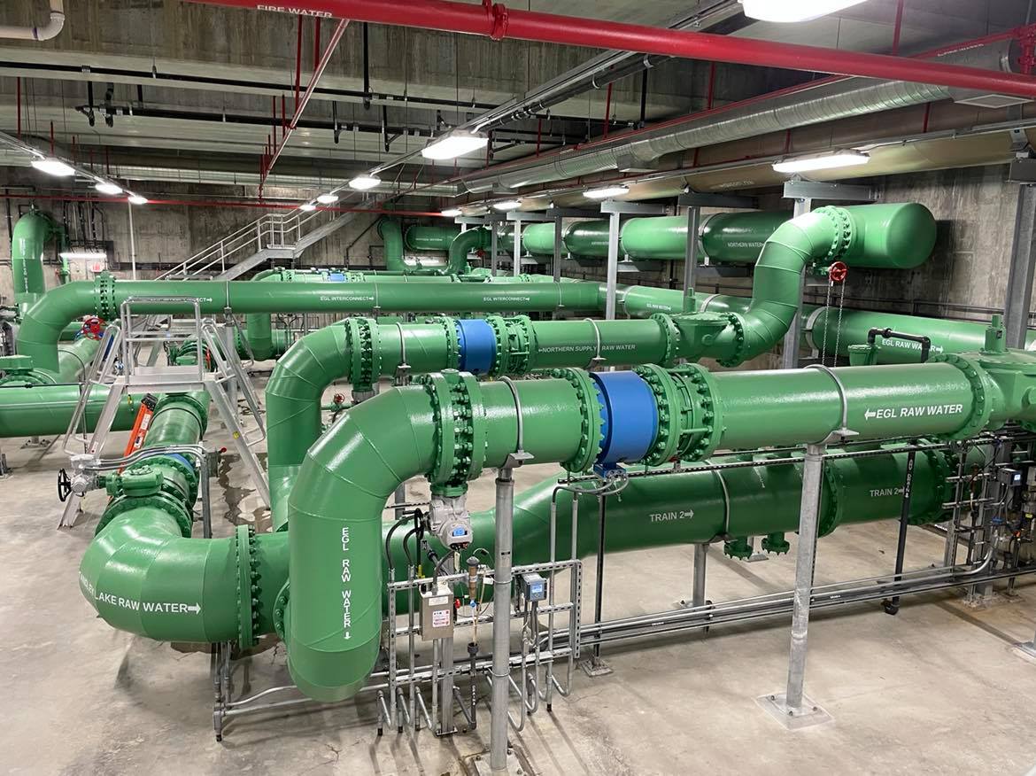 Huge green pipes inside the Thornton Water Treatment Plant