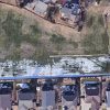 Aerial view of a rectangular detention pond surrounded by houses.
