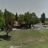 A large open park with a drainage detention pond in the middle