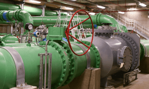 Large green pipes in water treatment facility