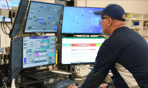 Operator working at multiple computer screens