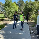 People on a path in a park examining plants