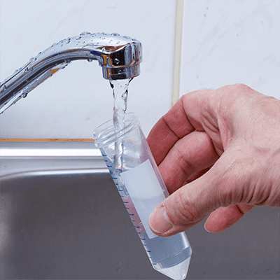 image of faucet pouring water into a test tube