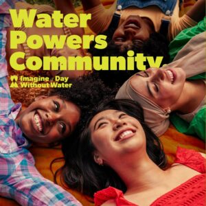 Four girls sit with their heads in a circle, smiling. Yellow text reads: "Water powers community, imagine a day without water."