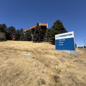civic-center-in-april-2026-6 Thornton administrative building and signage behind a brown lawn area